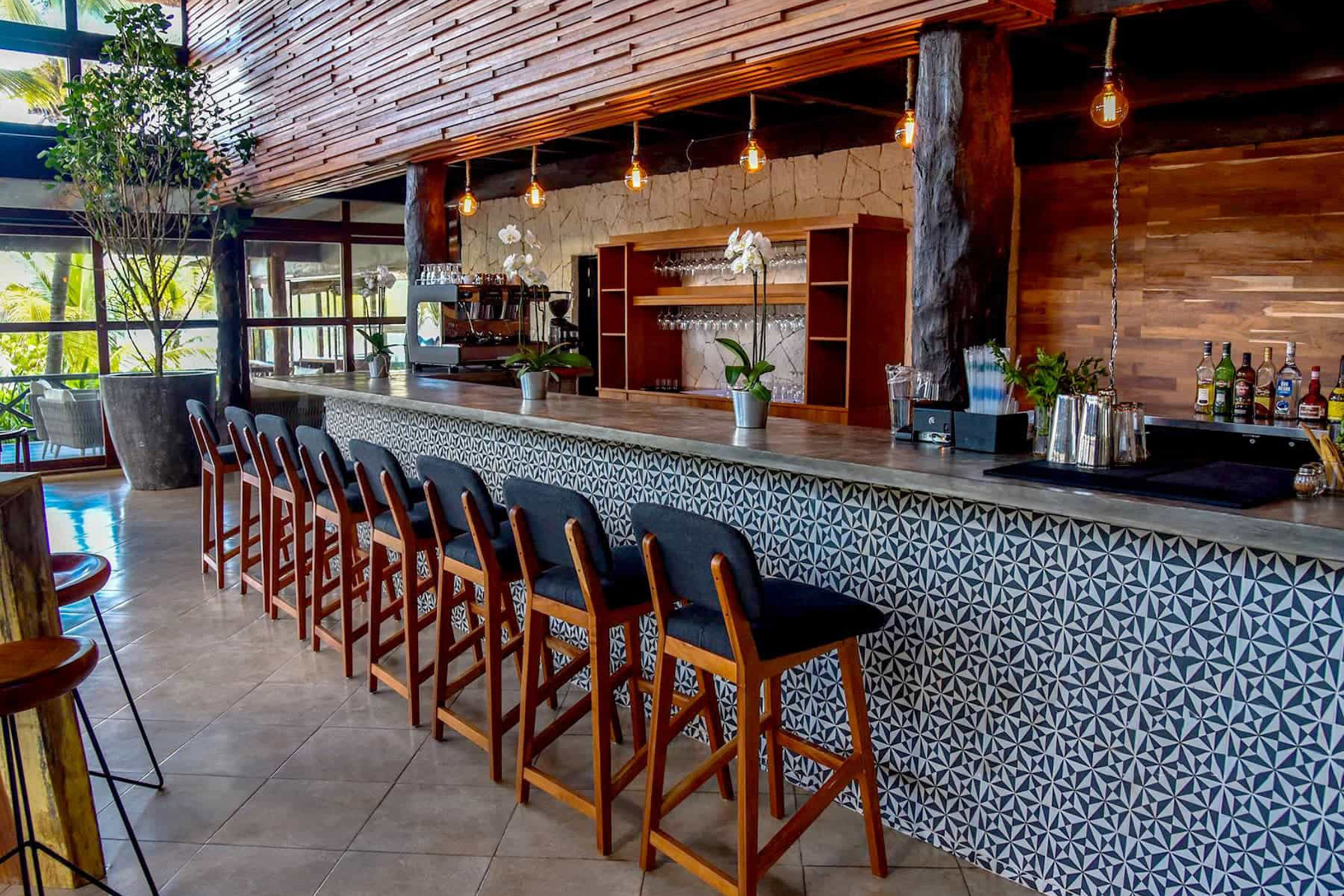 With the dense jungle on its back and the Caribbean sea lying on its feet, this hip meeting point brings together people who love top-notch food, well-crafted cocktails and socialising, always accompanied by positive vibes and good music. - Secondary Image