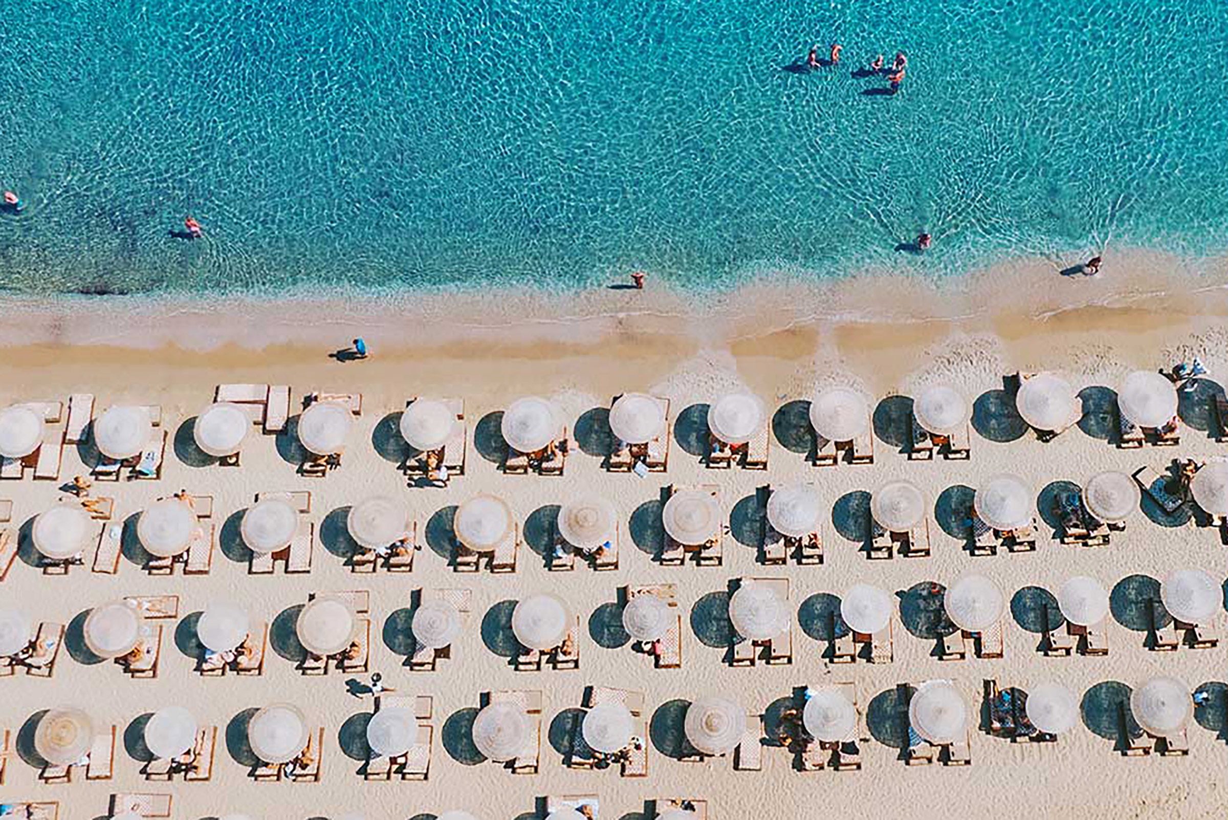 Solymar invites us to embrace the true spirit of Mykonos, through perfect food and drinks, amazing vibes, top-notch services, and a true sense of classy fun. Designed in total harmony with its stunning natural surroundings, Solymar looks like emerging from the golden sand of Kalo Livadi beach, one of the most gorgeous beaches on the island. - Secondary Image