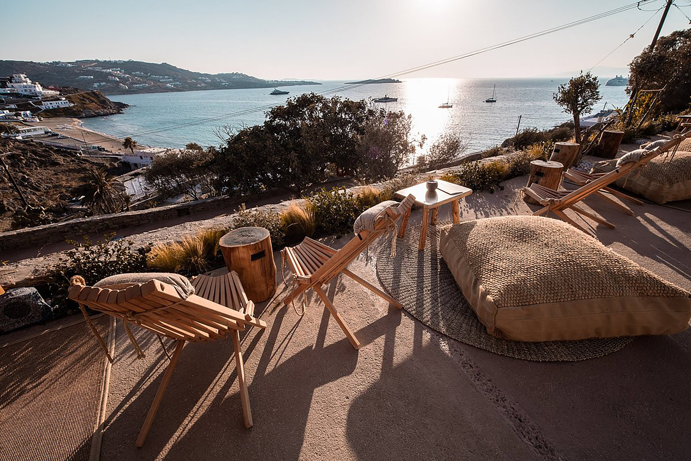 Earth tones and serene colours, natural wood and wicker, bohemian-chic surroundings and an elegant laid-back vibe makes The Garden of Mykonos a perfect choice for sunset chilling, paired with amazing cocktails served in handmade glassware and delicious snacks. - Secondary Image