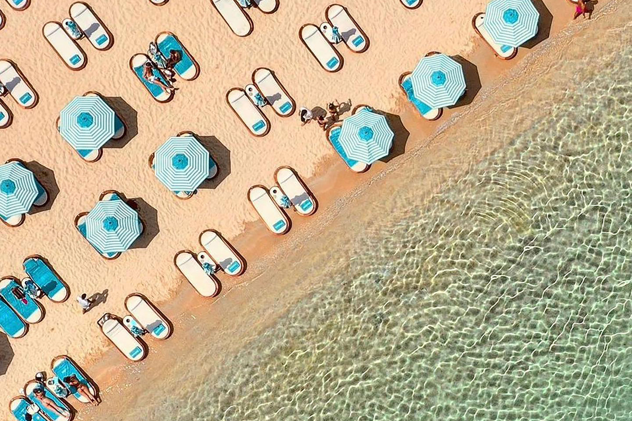 Nammos summarises the whole concept of the Mykonos glam and party scene on each regular summer day, as its daybeds are prebooked by the rich & famous months ahead and its restaurant hosts some of the biggest and most impressive parties on the island. - Secondary Image