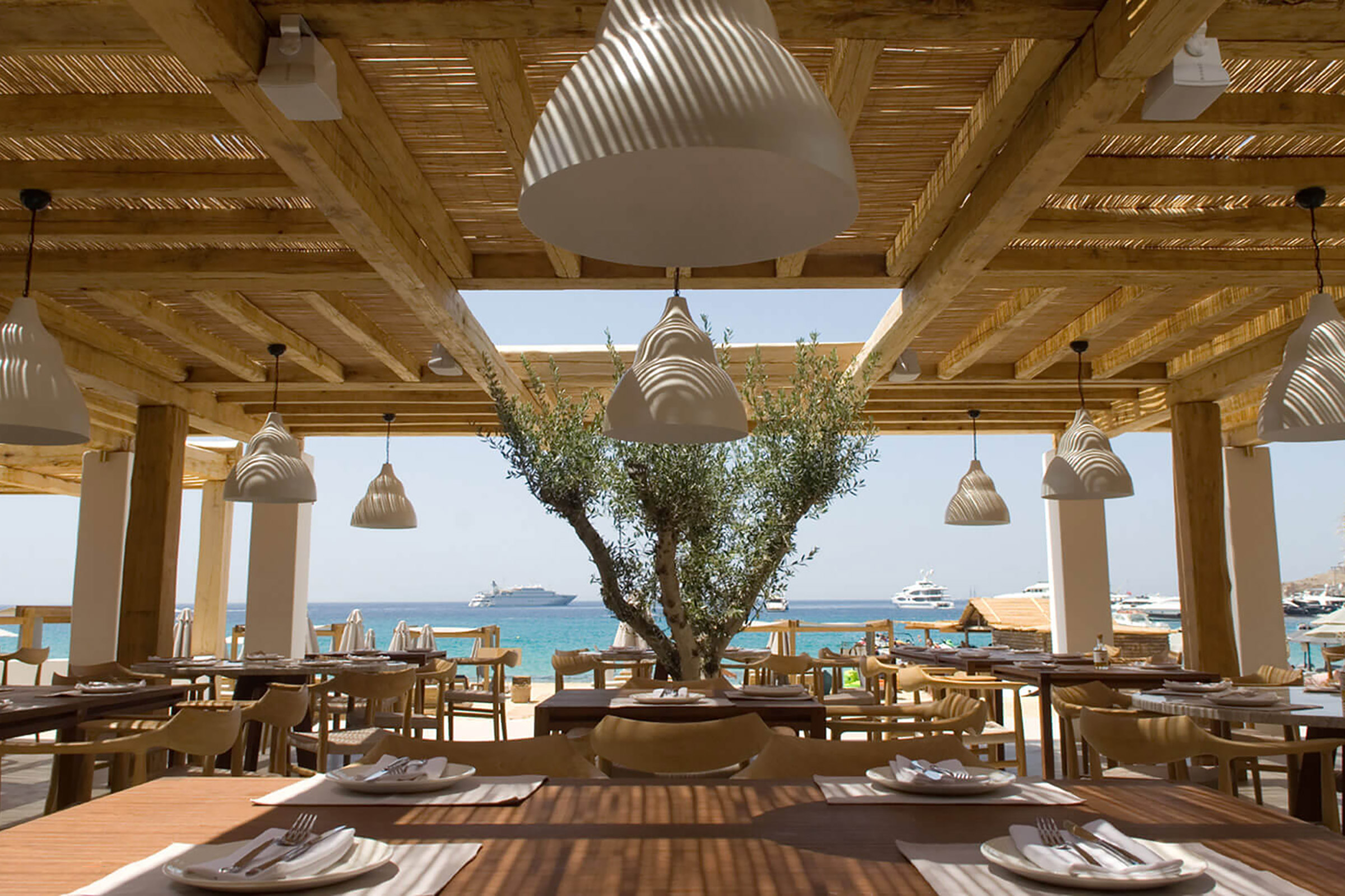 Focused on the exceptional quality of the freshest local produce and always looking for the most creative ways to reinvent the amazing tastes and recipes of the Greek cuisine, the talented chef of Branco sets the tables with the most mouth-watering choices for a delicious breakfast, a splendid lunch, or a fine dinner on the beach. - Secondary Image