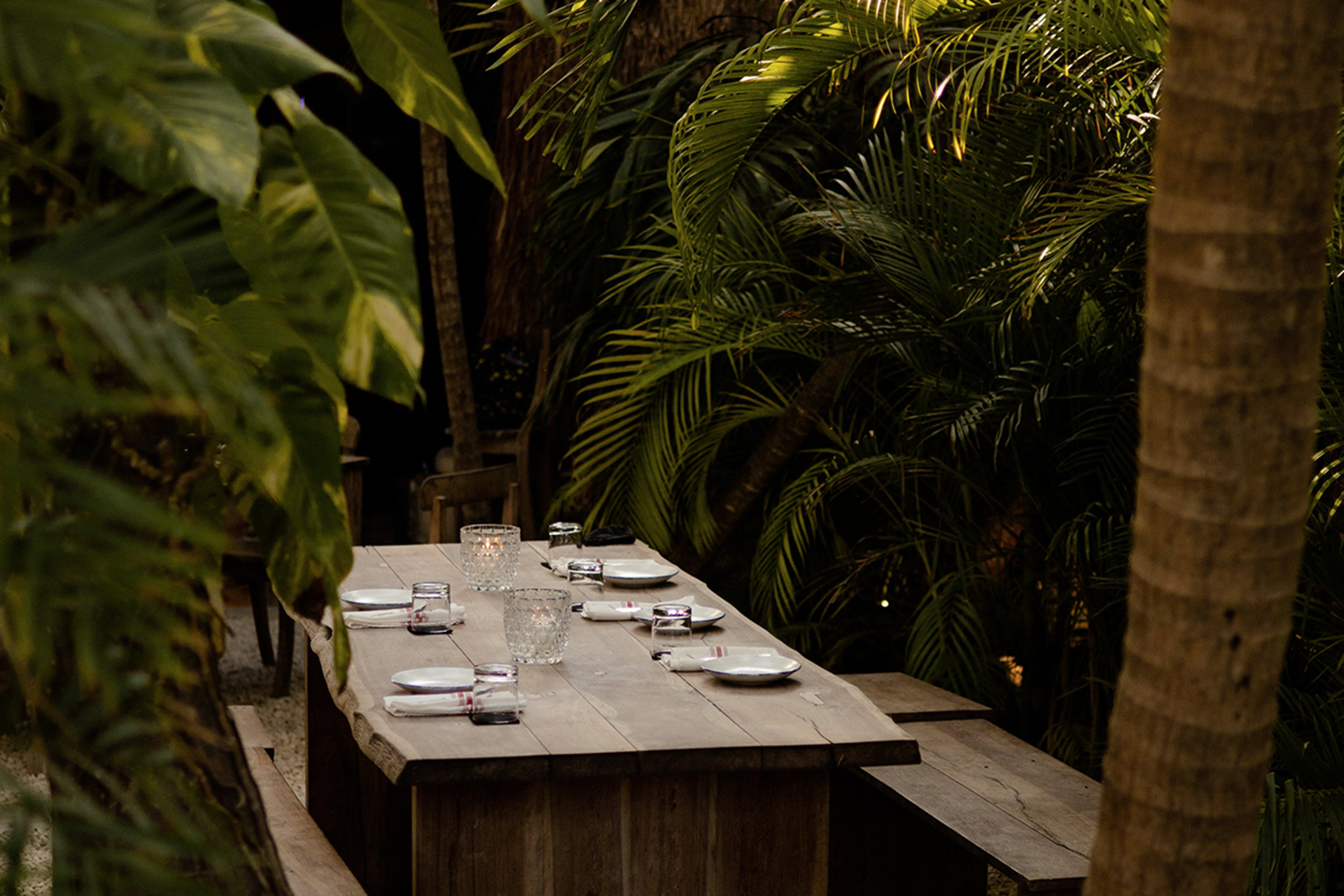 Within its much impressive jungle setting, the ultra-romantic, candlelit Nu Tulum offers a creative blend of traditional and modern Mexican cuisine, addressing the palates of the sophisticated foodies finding their way to its robust wooden tables, placed under the tall palm trees and the stars. - Secondary Image