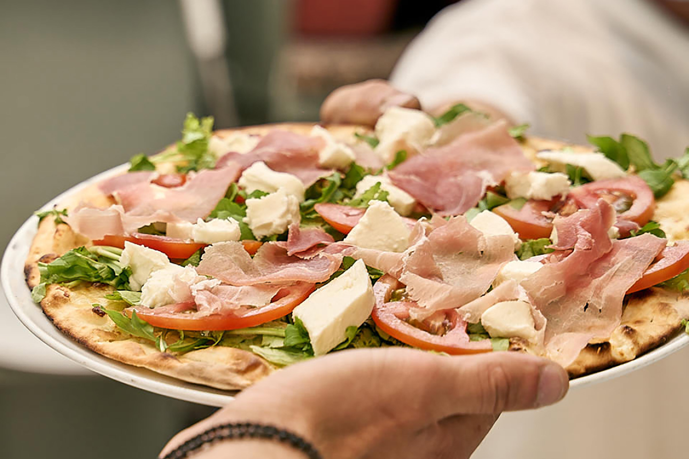 Famous for its thin-crust, Naples-style pizza that comes straight from the wood-oven, frosted with the freshest ingredients, but also for its amazing pasta fresca (fresh pasta), which is made daily in-house with only the best of local produce. - Secondary Image