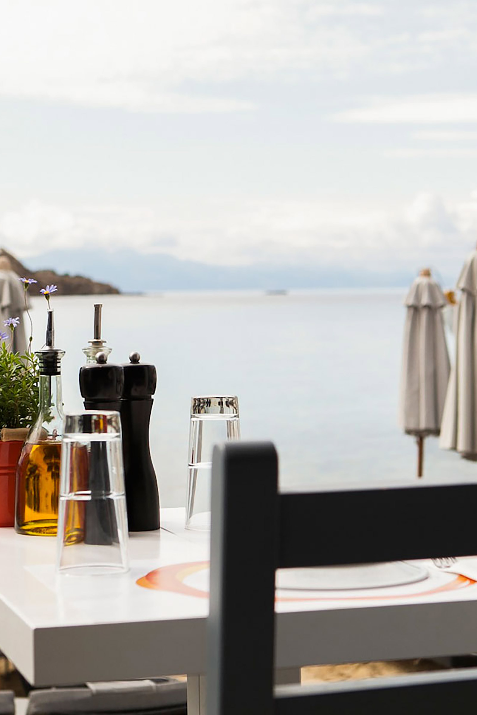 Decorated in a minimalistic style, in order to let the food and the unblocked sea views have the first word, the restaurant emphasises on top-quality ingredients of the local land and sea being transformed into delicious traditional Greek dishes with a contemporary twist, presented in the style and flair of the cosmopolitan destination you are in. - Image