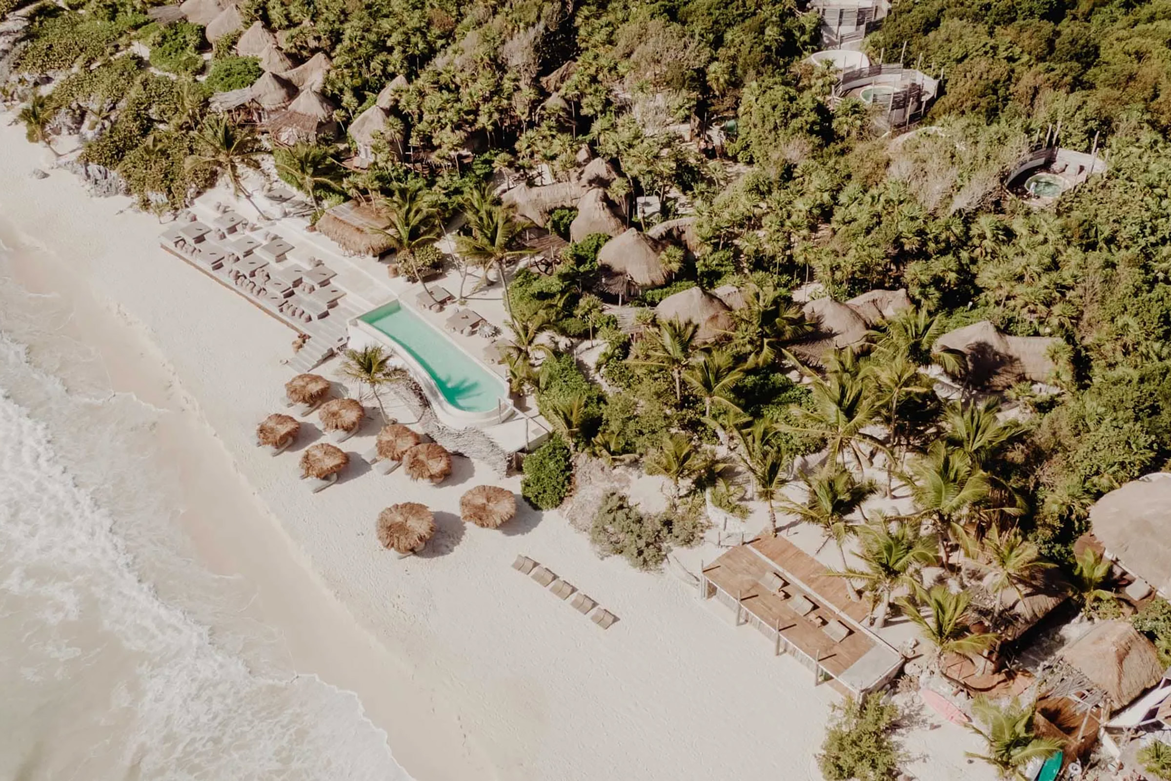 Papaya Playa Project, located on a wide, white-sanded, palm-fringed, private beach with pristine waters and stunning sunsets, is a barefoot-luxury haven for those seeking for an authentic exotic holiday feeling without further burdening the ecosystem. - Secondary Image