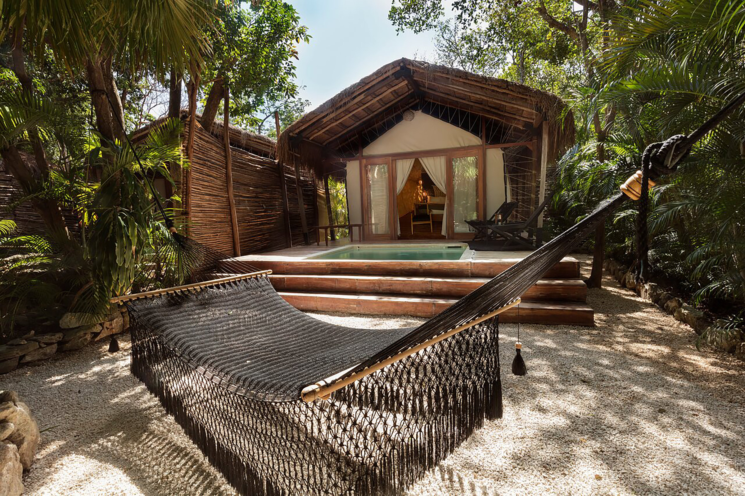 Palapa roofs, canvas walls, outdoor rain showers, extent use of local wood and wicker give the tempo for a cosy home-away-from-home totally blending in with the surrounding landscape. - Secondary Image