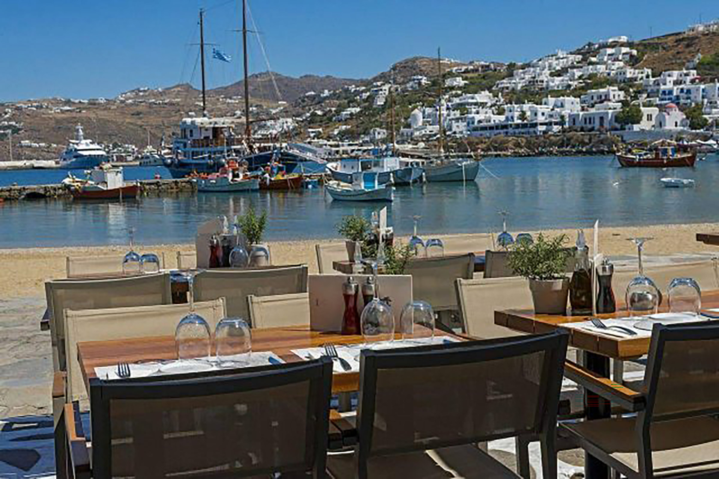 The building hosting this beautiful all-day bar restaurant for over two decades now is of huge historical significance to the island, as it belonged to heroine of the Greek War of Independence Manto Mavrogenous, a revolutionary soul who spent her entire fortune for the Hellenic cause. - Secondary Image