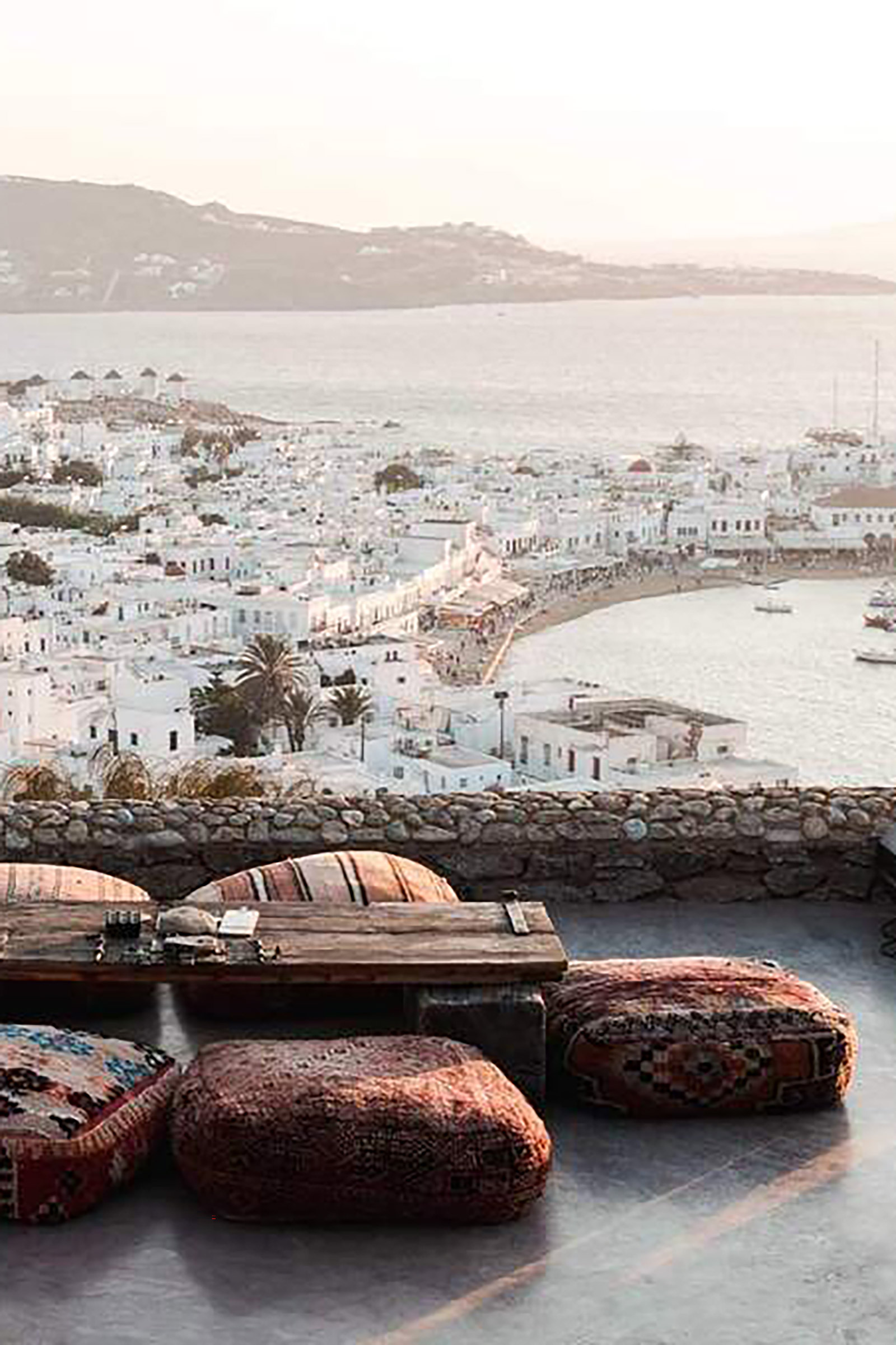 Located on the top of a hill overlooking Mykonos Town, this elegant, boho-chic, amazing venue is one of the most idyllic places to enjoy the sunset and get a much-promising night started. Designed to totally blend in with the surrounding natural landscape, 180° Sunset Bar offers a relaxing vibe from the first moment you set foot in it. - Image