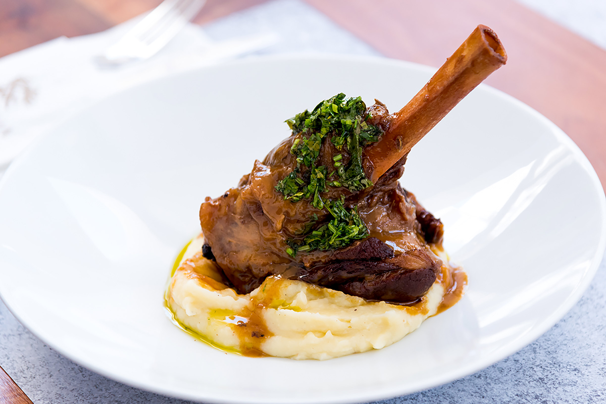 Enjoy a cool coffee, a freshly squeezed juice, a refreshing cocktail or a glass of fine wine, while sampling delicious dishes of Greek cuisine with a creative touch and an international flair. From the vine leaves sushi with yogurt flavoured wasabi to the gravlax salmon and from the shrimp “papoutsakia” to the traditional chilopites (Greek pasta), the menu of Kazarma celebrates out-of-the-box thinking and cooking. The friendly staff is always there to welcome you with a huge smile. - Secondary Image