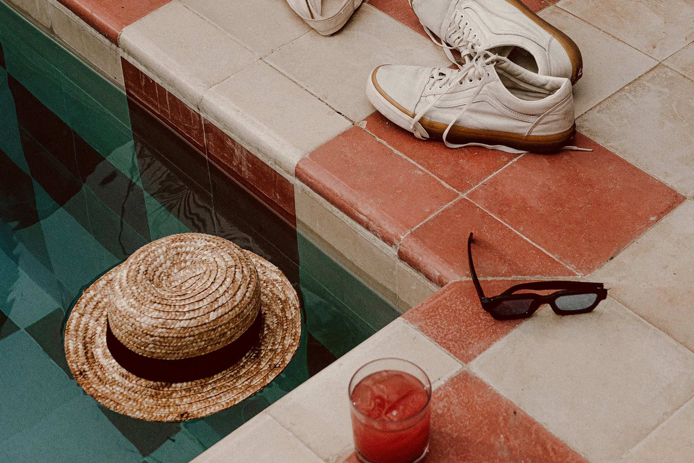 This beachfront lifestyle boutique hotel, with its characteristic thatched roofs and whitewashed settings, magnetises the eye with its unique, retro-chic, white and red pool, created by local artists with handmade vintage tiles, which calls ASAP for an Instagram post, surely to be envied by all your followers. - Secondary Image