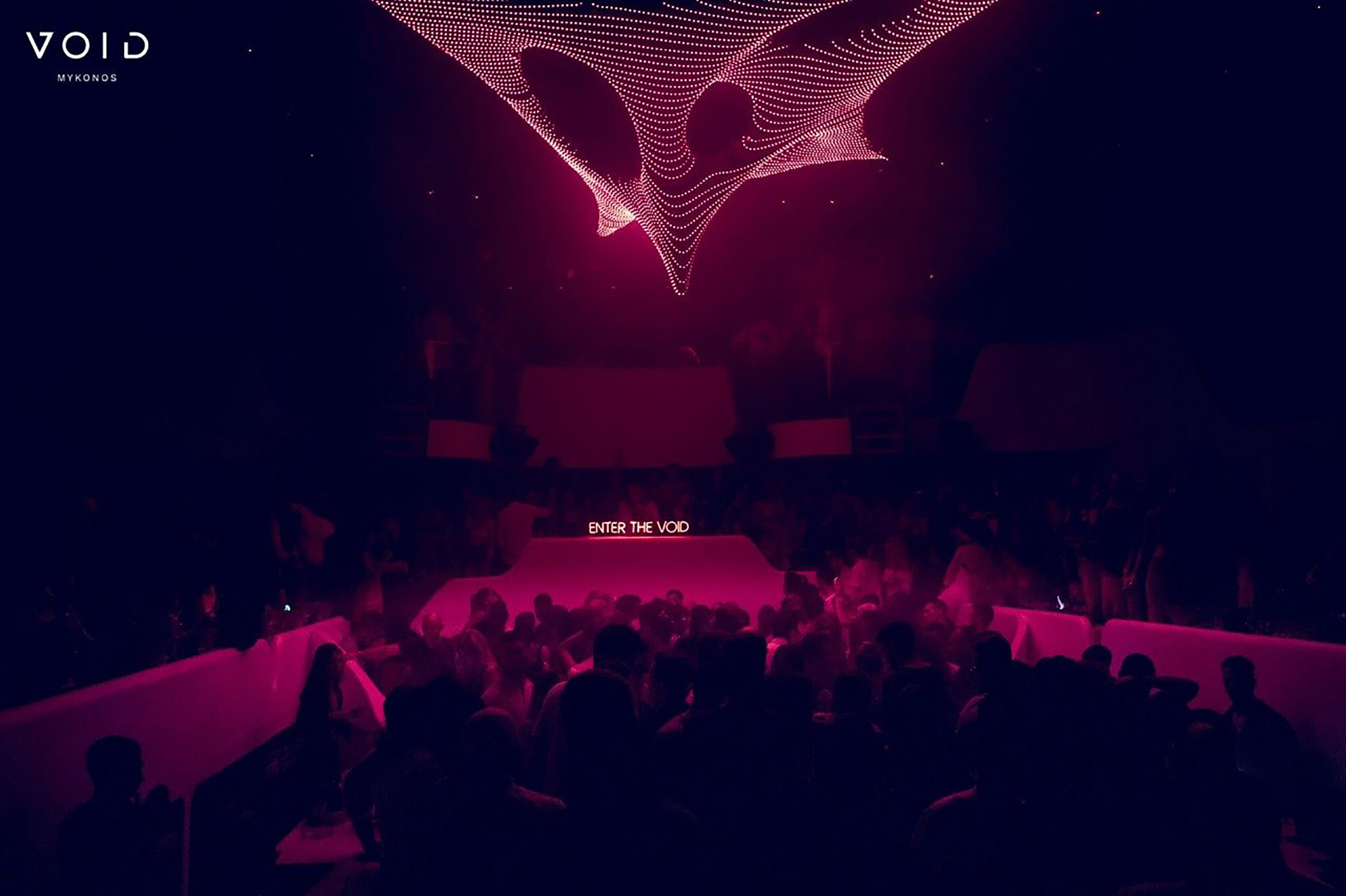 Smartly divided into three levels, the main club showcases the bar area and dancefloor; two huge, all-white bars offer all the space needed to mingle and socialise, while the extensive dance area is the best place to enjoy the impressive “void” lighting installation and amazing sound provided by the DJ hitting the decks just above your head. - Secondary Image