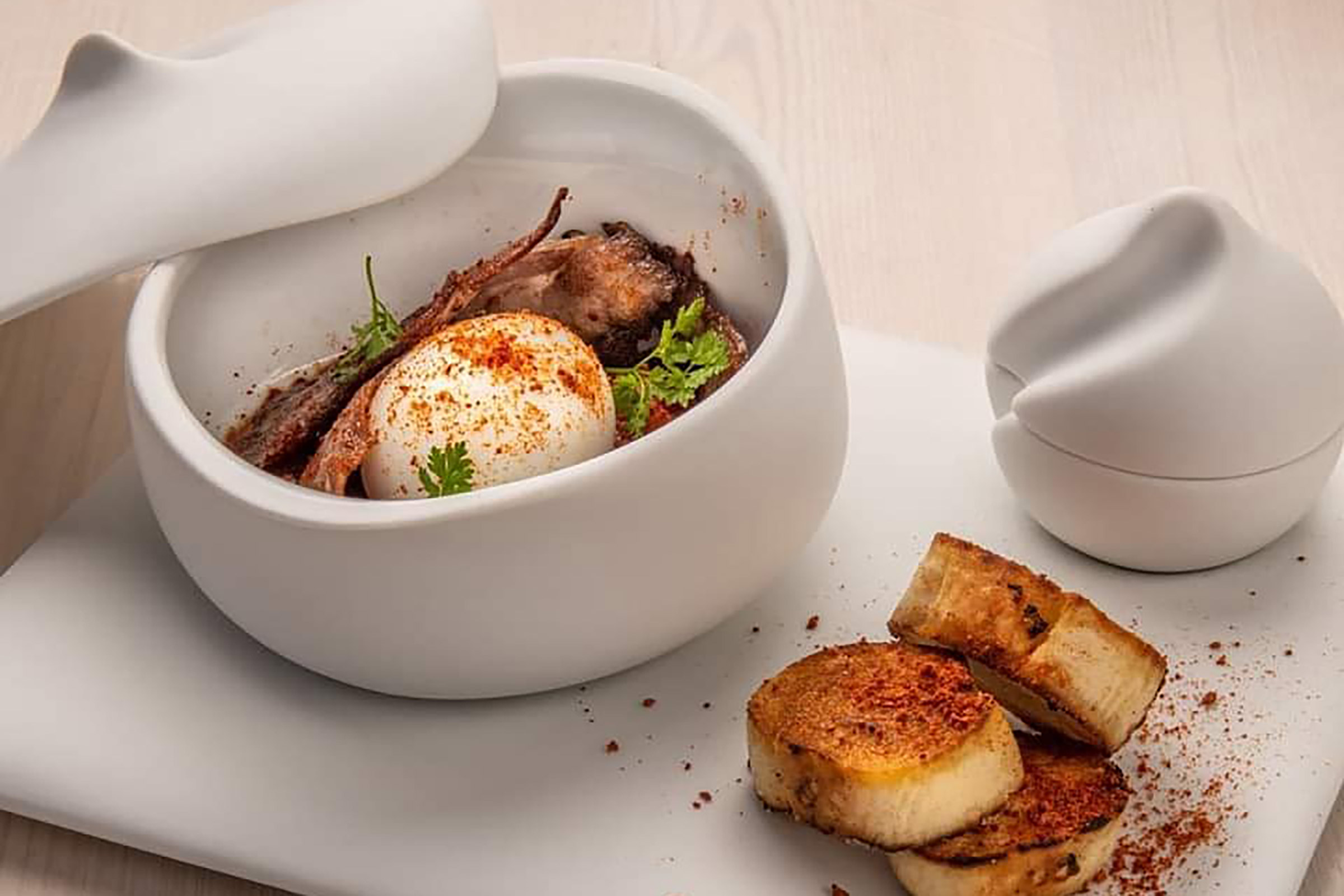 From the tantalising goat cheese trilogy and the meatballs “stifado” to the lavish goat with orzo “giouvetsi” and the grilled squid with cauliflower puree, here you will taste Greece on your plate and discover the greatness of sophisticated simplicity. - Secondary Image