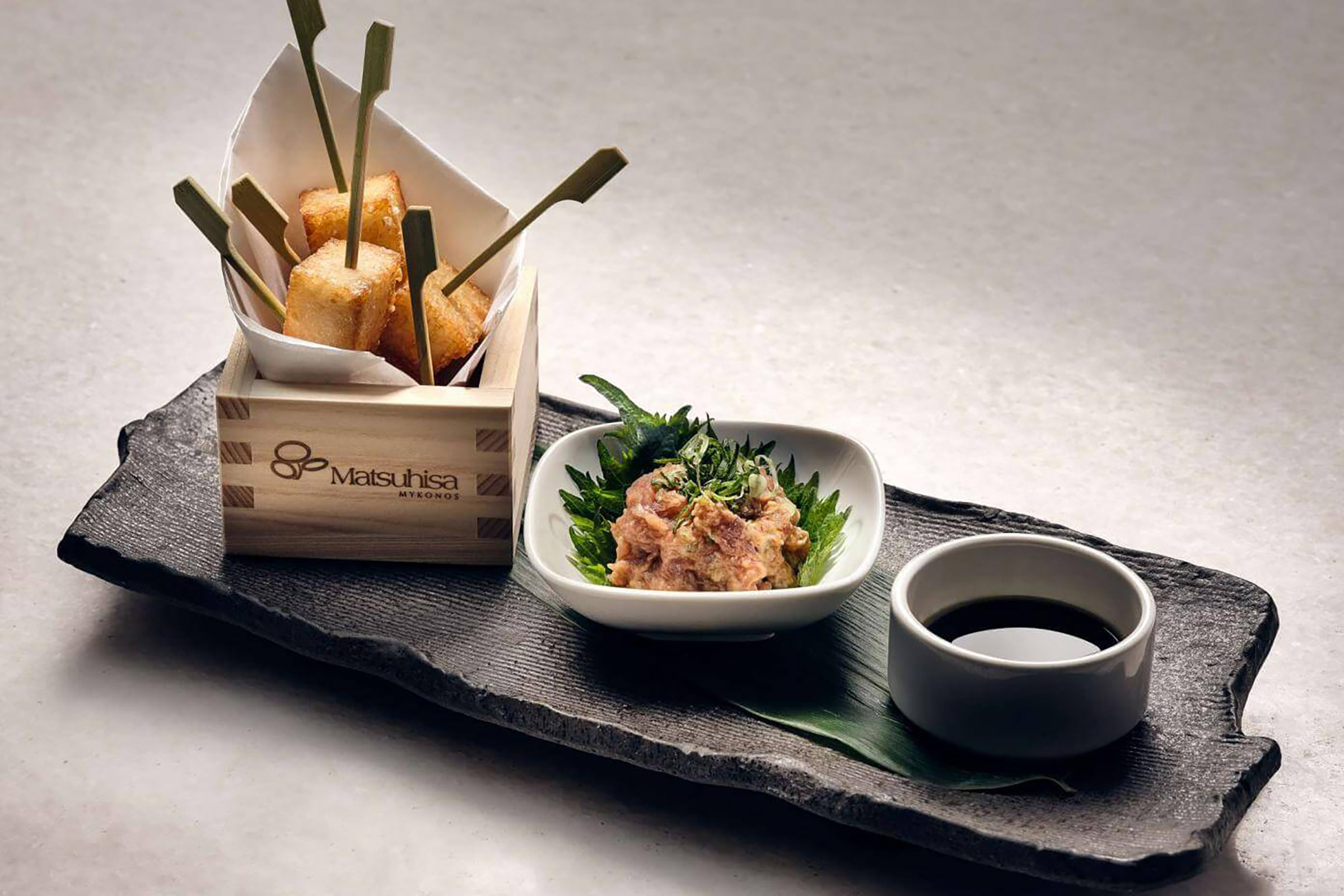 This stunning venue is where you will sample the emblematic black cod, along with a selection of the global favourites, including the rock shrimp salad, the yellowtail jalapeno, the white fish dry miso, the salmon karashi su miso and the sashimi salad, complemented by the daily specials featuring Greek fish and seafood straight from the Aegean Sea. - Secondary Image