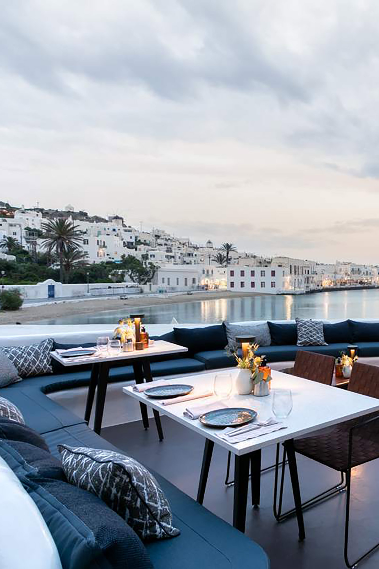 Gracefully nestled on the north end of Mykonos town, the legendary Remezzo offers one of the best views of the old port and an unappareled ambiance of summer bliss. Some of the best Mykonos stories begin with the phrase “and we were having a drink at Remezzo and…”, as this stunning venue has been part of the Mykonian nightlife myth since 1967. - Image