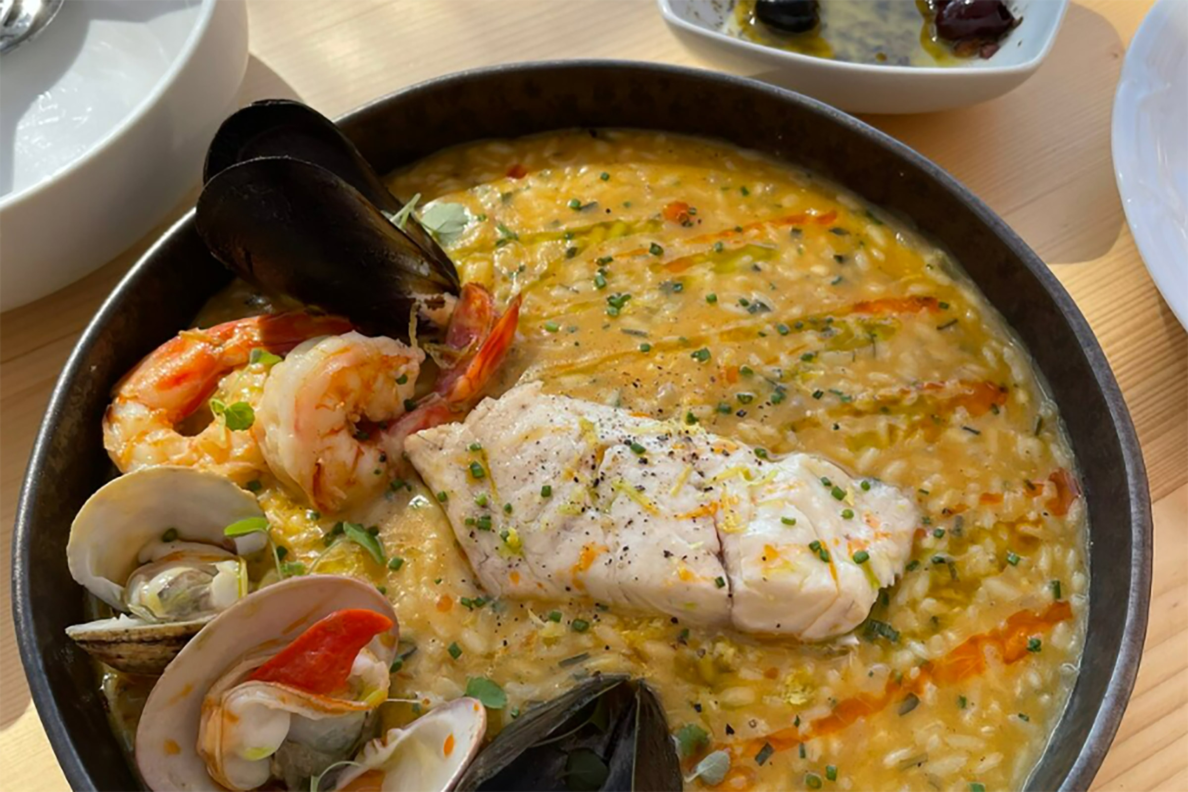 Renowned Greek chef Ilias Skoulas has created an elevated menu that will satisfy even the most demanding of palates, with the crab croquette bao buns placed next to the iconic linguini cacio e pepe and the fresh Greek grilled tuna with beetroot cream putting a fair fight against the foie gras burger. The fruit-forward cocktails are an absolute “must”, while the wine list will surely not let you down with amazing labels from the Greek and the international vineyard. - Secondary Image