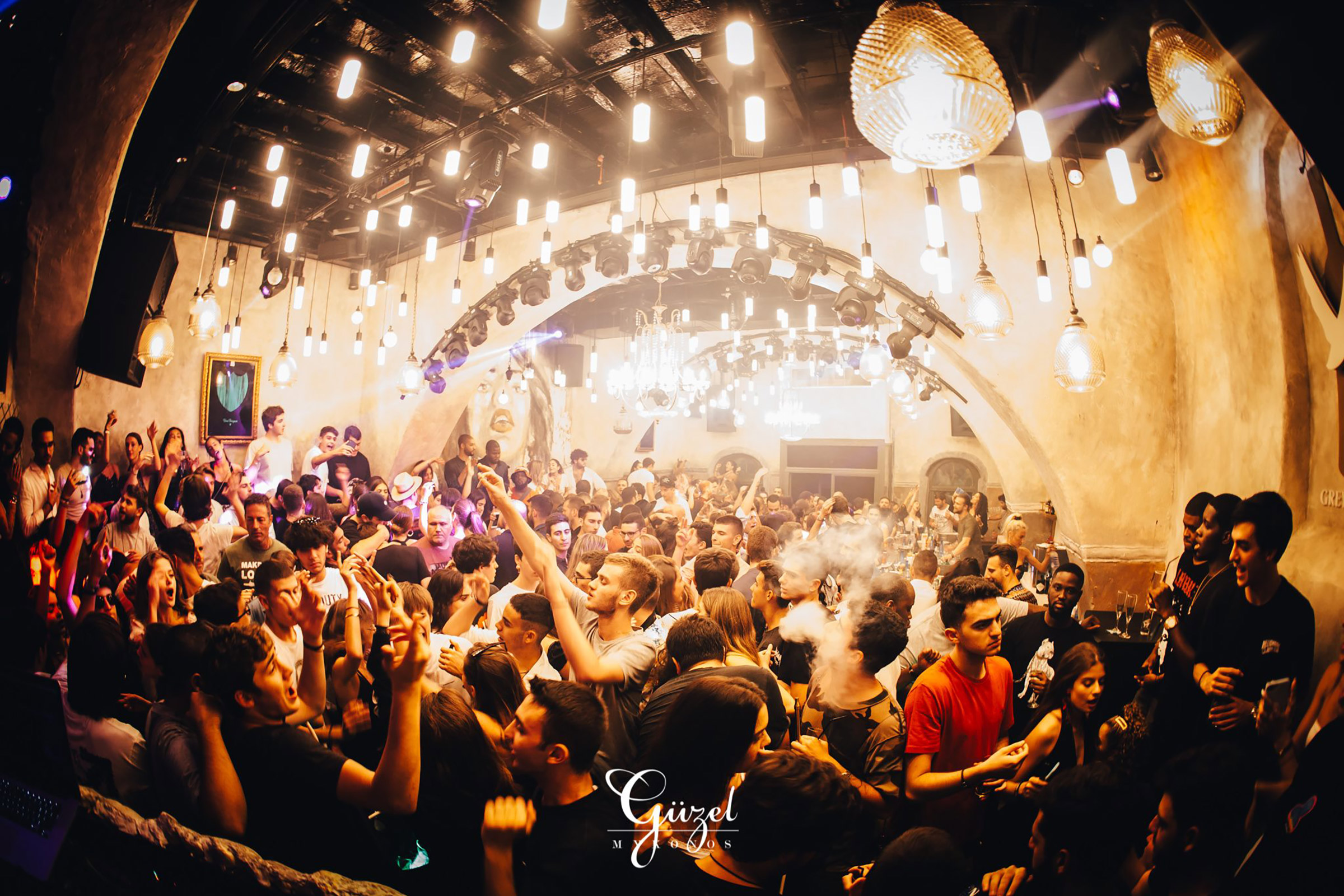 Located on the Mykonos Town waterfront, literally on the sea, the well-established Guzel Club Restaurant offers in abundance all that is needed for a perfect night out, full of dancing, drinking, partying, flirting, kissing and well… clubbing. - Secondary Image