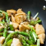 Een lekkere roerbak maaltijd: gebakken kipfilet, asperges en champignons.