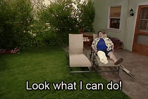 Stuart from Mad TV jumping across a lawn yelling “Look what I can do!” while a guy in a leg cast and clutches lies on a deck chair.