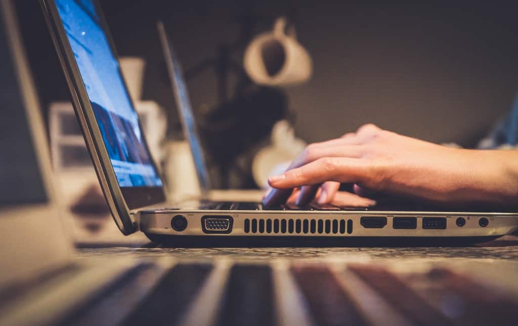 persona che lavora con il laptop alla scrivania