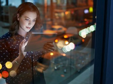 Frau chattet am Tablet mit WhatsApp
