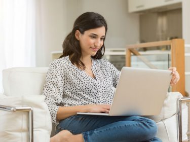 Junge Frau nutzt an ihrem Laptop den Google Chrome-Browser.