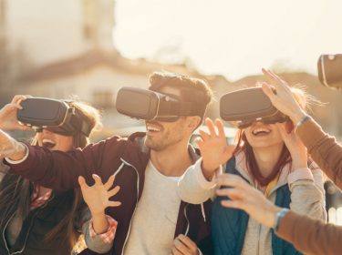 Freunde erleben Virtual Reality über eine VR-Brille.