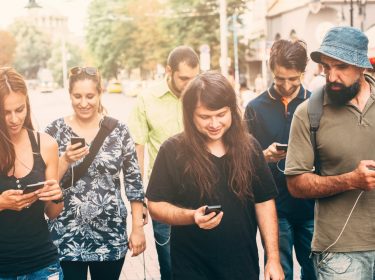 Mehrere junge Leute mit jeweils anderen Smartphones
