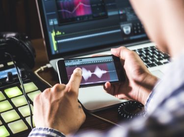 Mann macht im Tonstudio Musik mithilfe einer DJ-App