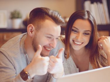 Junges Paar nutzt Snapchat auf dem Laptop.