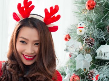 Junge Frau nimmt Video mit ihrem Memoji am Smartphone auf.