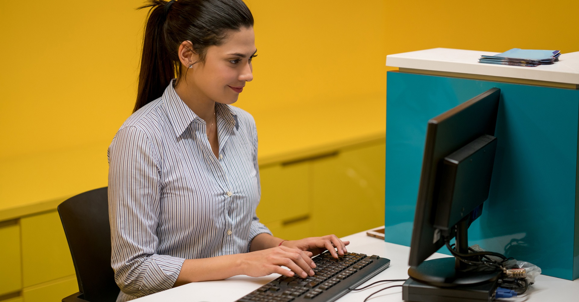 Junge Frau arbeitet mit Tastatur an Computer