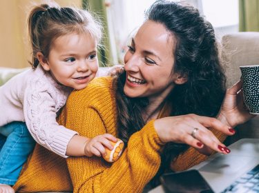 Mutter und Kind liegen auf der Couch