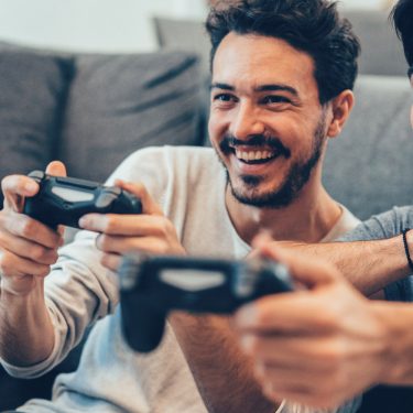 Two Young Men Playing Video Game