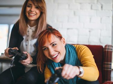 Zwei Frauen spielen ein Konsolenspiel
