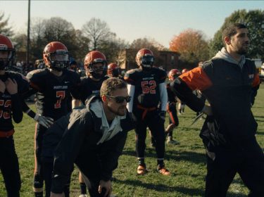 Zwei Trainer am Rand eines Football-Felds bei einem Spiel