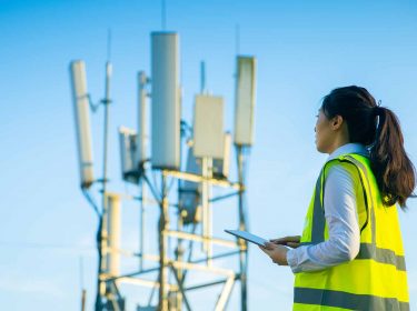 Eine Ingenieurin bei der Arbeit an einem Telekommunikationsturm