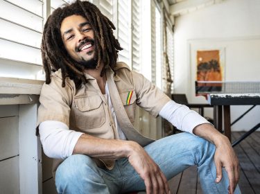 Bob Marley (Kingsley Ben-Adir) schaut in die Kamera und sitzt in einer lässigen Pose