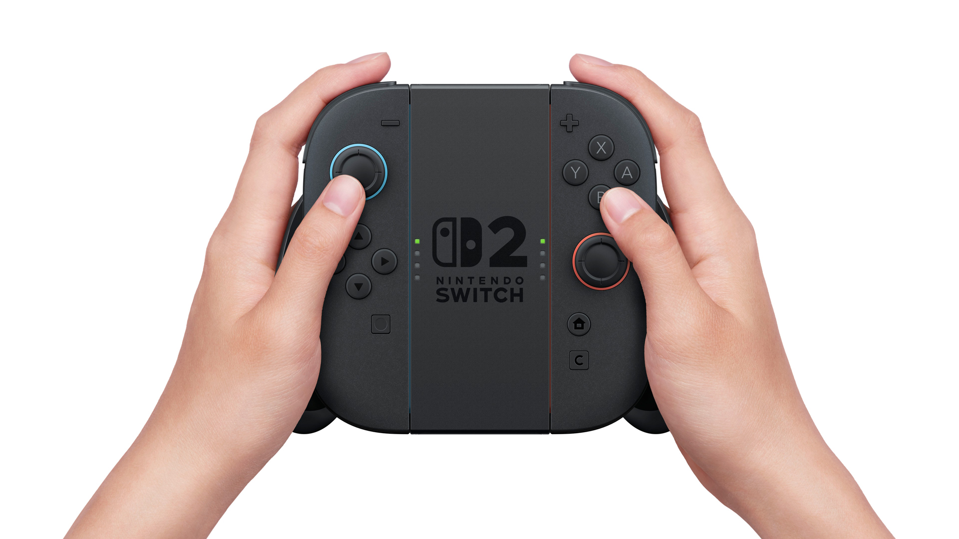 Das Bild zeigt die neue Halterung der Nintendo Switch 2, in der zwei Joy-Con-Controller als klassischer Controller verbunden sind. Beide Hände halten das Gamepad, mittig ist das „Nintendo Switch 2“-Logo zu sehen. Die geänderte Halterung unterstreicht die Switch 2 vs. Switch 1 Unterschiede in puncto Flexibilität, Form und Handhabung im Controller-Modus.