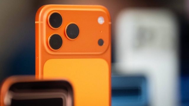 Die obere Hälfte des iPhone 17 Pro in Cosmic Orange, im Hintergrund weitere iPhones.