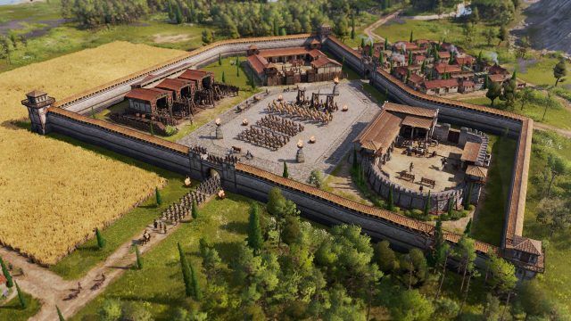 Im Screenshot aus Anno 117: Pax Romana ist eine römische Militäranlage zu sehen, umgeben von einer massiven Steinmauer mit Wachtürmen. Im Innenhof formieren sich Legionäre und Reiter in präziser Formation, flankiert von Katapulten. Rechts liegt ein befestigter Kommandoposten, links Werkstätten und Ställe.