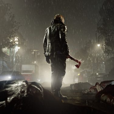 Leon S. Kennedy steht im Dunkeln auf einer Straße. Um ihn herum liegen erledigte Untote, er hält eine Axt in der Hand.