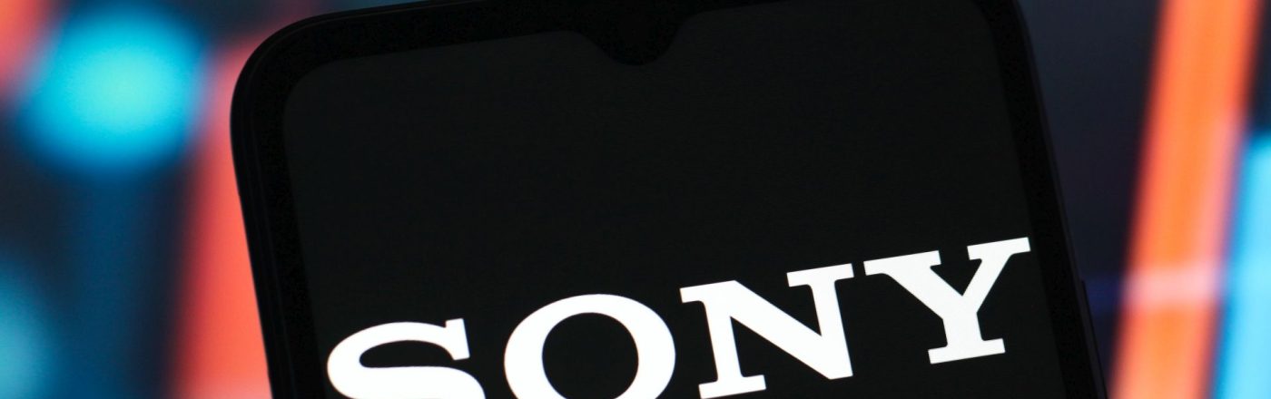 In dem Foto ist ein Handy zu sehen, auf dessen Display das Sony-Logo angezeigt wird.