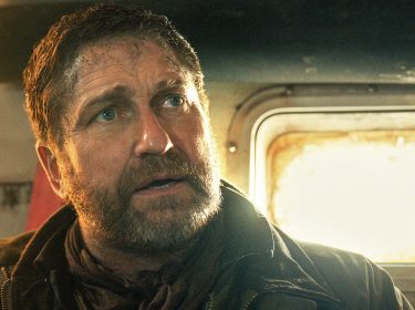 Gerard Butler in Greenland 2: Ein Mann blickt verzweifelt in einer Fahrzeugkabine bei grellem Licht.