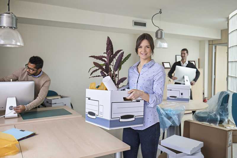 People in an office are packing up