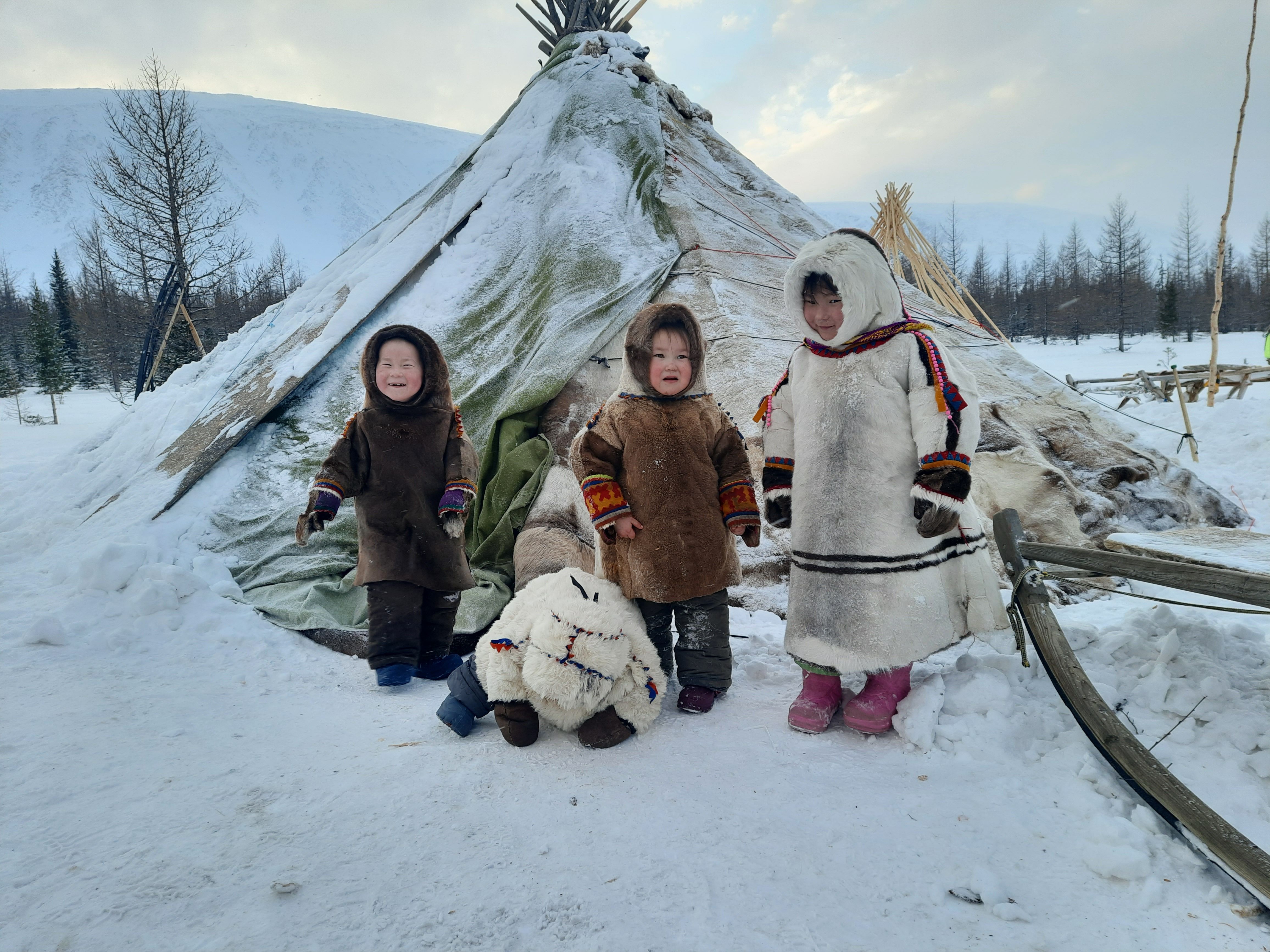 Photo by Sergei Shilenko: https://www.pexels.com/photo/a-group-of-children-wearing-parkas-beside-a-tupik-12017743/